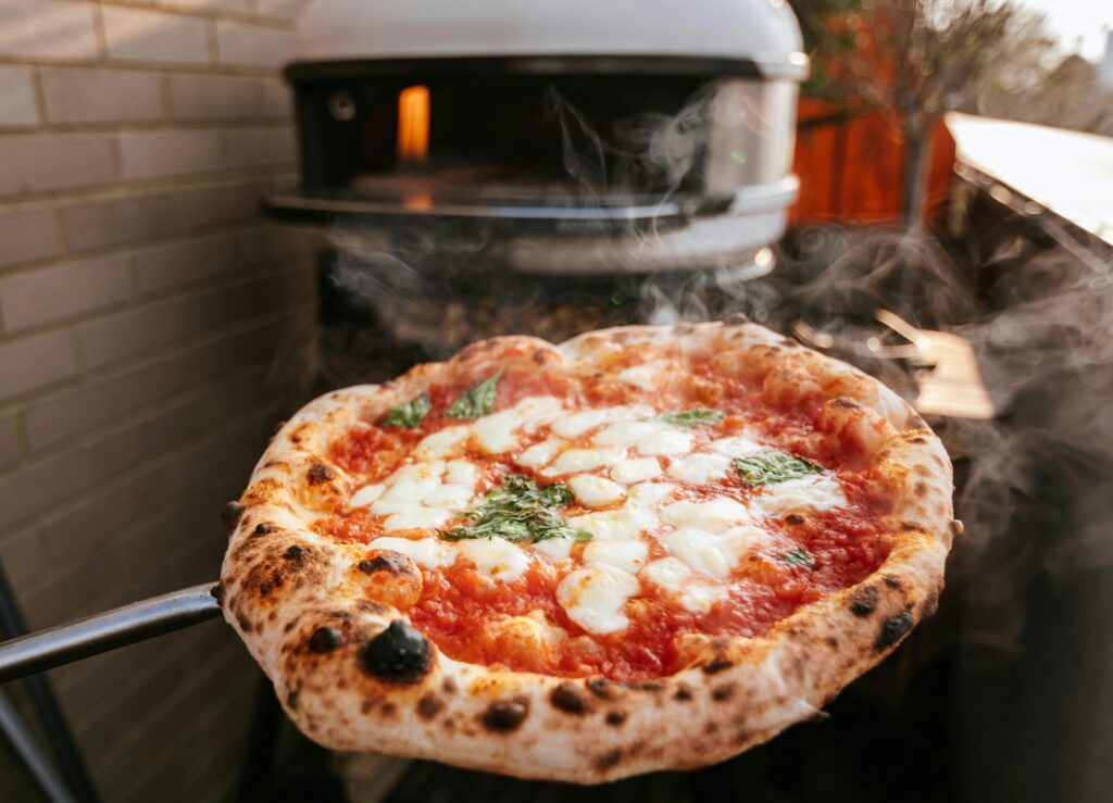 Gozney Arc and Gozney Arc XL pizza ovens side by side showing difference in cooking deck size