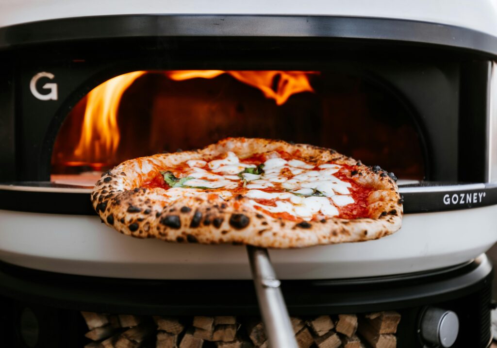 Home pizza oven heating up outdoors before cooking pizza